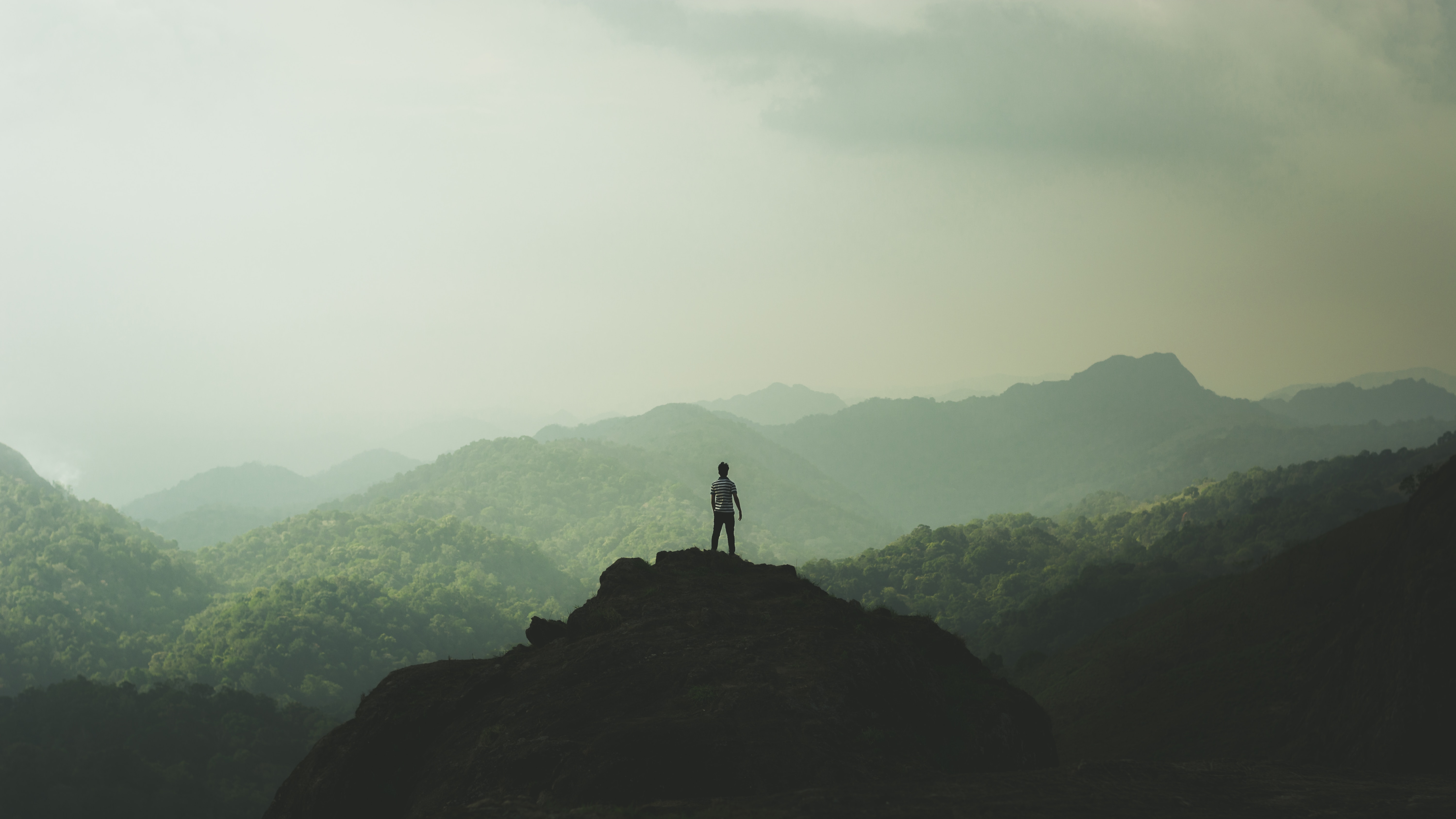man on mountain photo by alfred-aloushy
